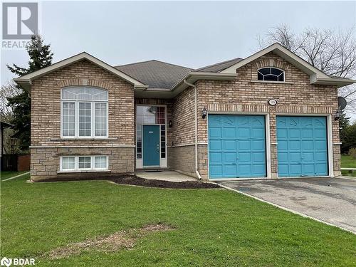 View of front of house featuring a garage and a front lawn