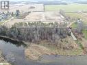 Birds eye view of property with a rural view and a water view Birds eye view of property with a rural view and a water view