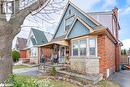 Bungalow featuring fence, board and batten siding, and brick siding Bungalow featuring fence, board and batten siding, and brick siding