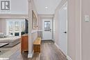 Doorway with dark wood-style floors, baseboards, and recessed lighting Doorway with dark wood-style floors, baseboards, and recessed lighting