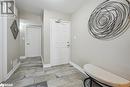 Foyer with baseboards, a textured ceiling, and light stone finish floors Foyer with baseboards, a textured ceiling, and light stone finish floors