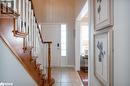 Entrance foyer with baseboards, stairs, and light tile patterned floors Entrance foyer with baseboards, stairs, and light tile patterned floors