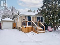 Long paved drive leads to detached single garage