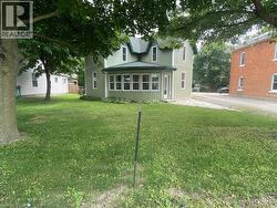 Rear view of property with a yard