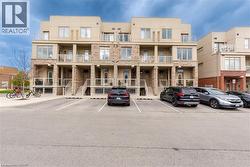 View of apartment building / complex with uncovered parking and stairway