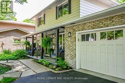 Welcoming front porch surrounded by landscaping.