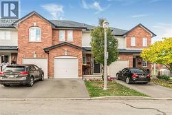 Traditional home with brick siding, driveway, and a garage