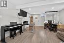 Spacious room featuring laminated flooring, recessed lighting, an elevator & three closets.