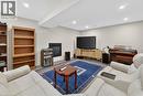 Recessed lighting illuminates this room featuring a natural gas fireplace.