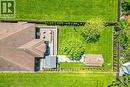 Expansive backyard featuring a manicured lawn, two mature trees, and a wooden deck, patio, walkways, fully fenced yard.