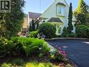 Stucco. Exposed beams, newly top-coated driveway. Antique lanterns