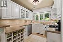 Maytag fridge and dishwasher. Wine rack. Heated floor. Jenn-aire dual fuel gas/electric range. Granite counter. Plantation shutters. Kohler sink.