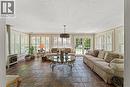 Copper slate flooring. Heated floor. Vermont stove. Updated fixture. French doors to deck are 'true-divided lights'.