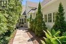 Flagstone walkway to front door. Cedar privacy hedge. Antique exterior coach lights.
