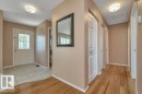 Entryway featuring a decorative glass panel door and a tiled floor