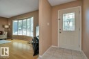 Entryway featuring an insulated door with decorative glass insert, complemented by tiled flooring