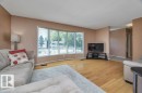 Living area featuring a wide bay window and light wood-finish flooring