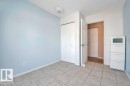 Room featuring light blue walls, neutral tile flooring, and a flush mount ceiling light