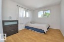Room with wood-finish flooring and white walls