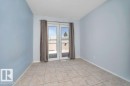 Interior room with light blue walls and neutral-toned tile flooring