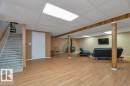 Finished lower level featuring wood-finish flooring and recessed lighting