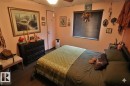 The property features hardwood floors, a ceiling fan, and a window with blinds