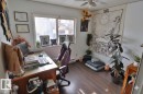 This room features hardwood flooring, a ceiling fan, and a window providing natural light