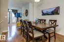 Dining area featuring wood-finish flooring and a contemporary overhead light fixture