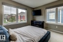 Spacious room featuring neutral painted walls, light-toned carpet flooring, and white trim