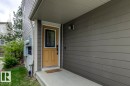 Entryway with a light tan door featuring a decorative glass insert