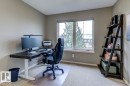 Bright room with a large window, neutral wall paint, and beige carpet flooring