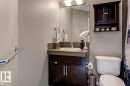 Bathroom featuring a dark wood-finish vanity with an integrated sink and a neutral countertop