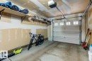 Single-bay garage featuring a sectional overhead door with upper window inserts and an automatic opener