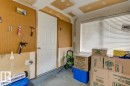 Garage space featuring a paneled door, pegboard wall, and a window with horizontal blinds