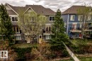 Townhome exteriors featuring multiple levels, balconies with black railings, and a mix of siding materials