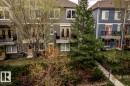 Multi-level townhome featuring a private balcony with black metal railing