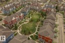 Aerial perspective of a residential development featuring townhomes surrounding a central green space