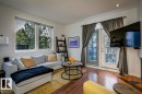Living area featuring wood-finish flooring and recessed lighting