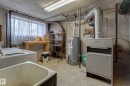 Utility area featuring a laundry sink, washing machine, and a window with natural light