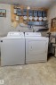 Dedicated utility area featuring a washer and dryer, multiple electrical panels, and utility meters