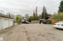 Two-car detached garage with white garage doors
