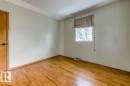 Room with light-toned walls, wood-finish flooring, and a single window
