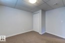 Neutral wall paint with carpeted flooring and white baseboards