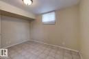 Room featuring ceramic tile flooring, neutral wall paint, white baseboards, and a single window with blinds