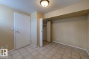Neutral tone walls with a flush-mount ceiling light