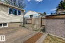 Paved patio area featuring interlocking pavers with a stone border