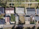 Overhead perspective showcasing multiple residential properties, each featuring individual rear yards