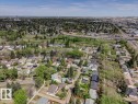 Expansive aerial perspective showcasing a residential area with varied housing styles and mature trees