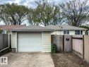 Single-car garage with an overhead door and concrete driveway