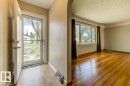 Entryway featuring tile flooring and a white front door with an integrated screen door